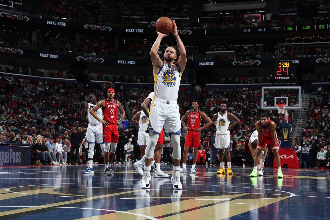 Stephen Curry shoots a free throw during the game against the New Orleans Pelicans during the game in New Orleans, Louisiana. The Pelicans’ court is dark grey and gold for the occasion.