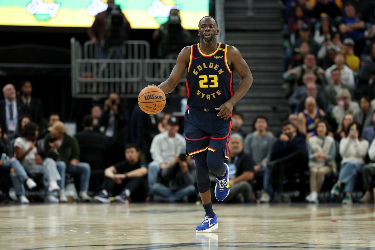 Draymond Green dribbles the ball against the Brooklyn Nets at Chase Center. The Warriors are wearing their City Edition jerseys.