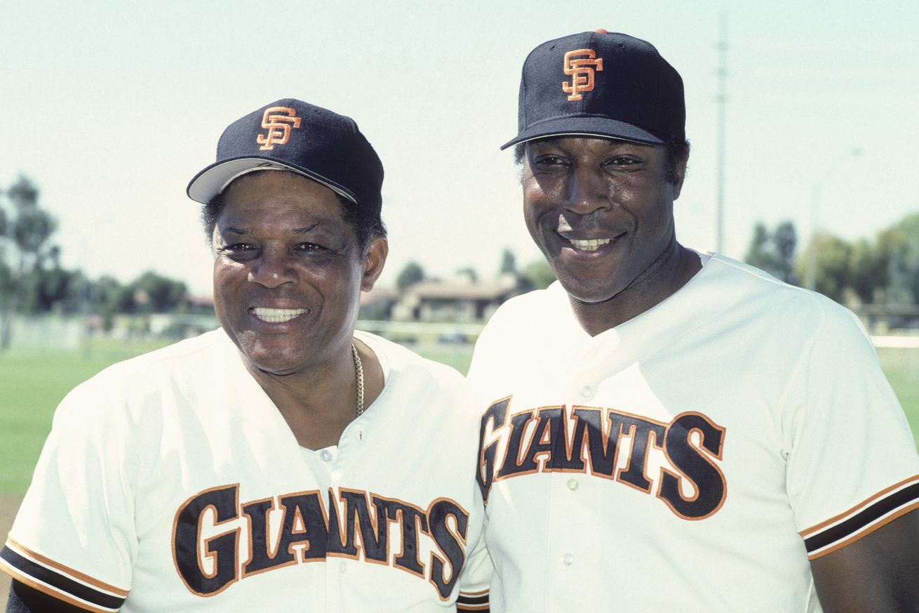 Willie McCovey standing next to Willie Mays in 1986, in Giants jerseys. 