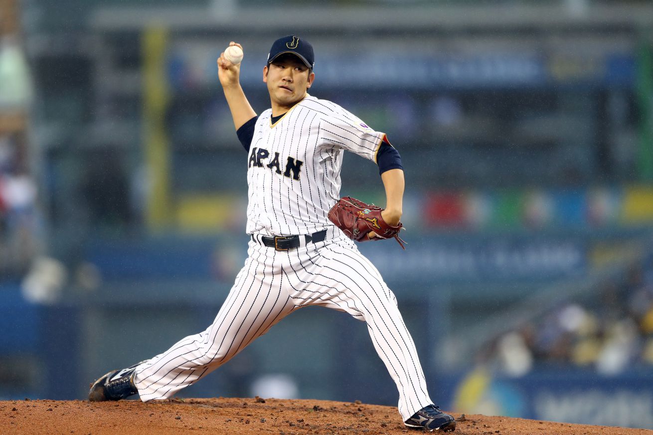 Tomoyuki Sugano stepping forward to throw a pitch. 