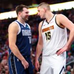 Dallas Mavericks guard Luka Doncic (77) speaks with Denver Nuggets center Nikola Jokic (15)