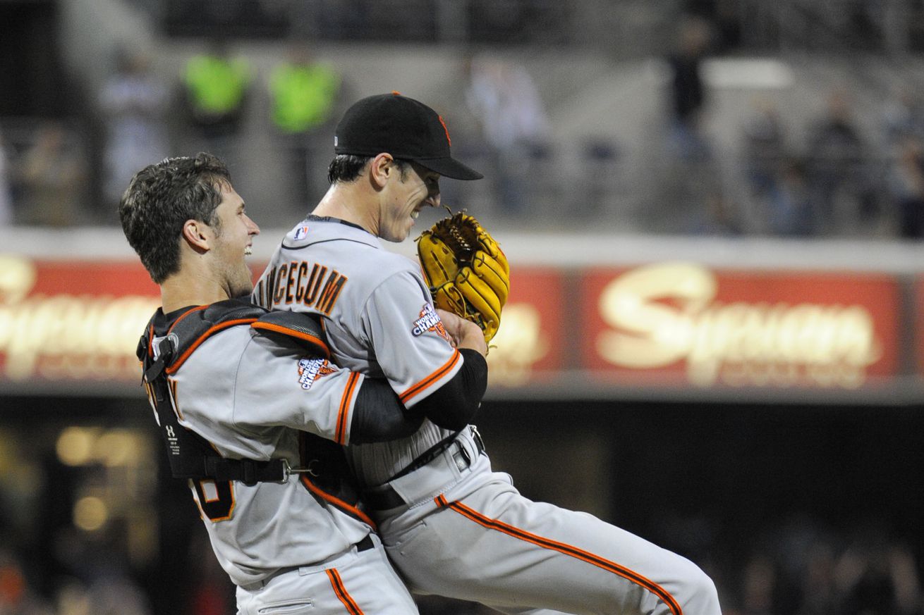 Buster Posey lifting Tim Lincecum up in celebration. 