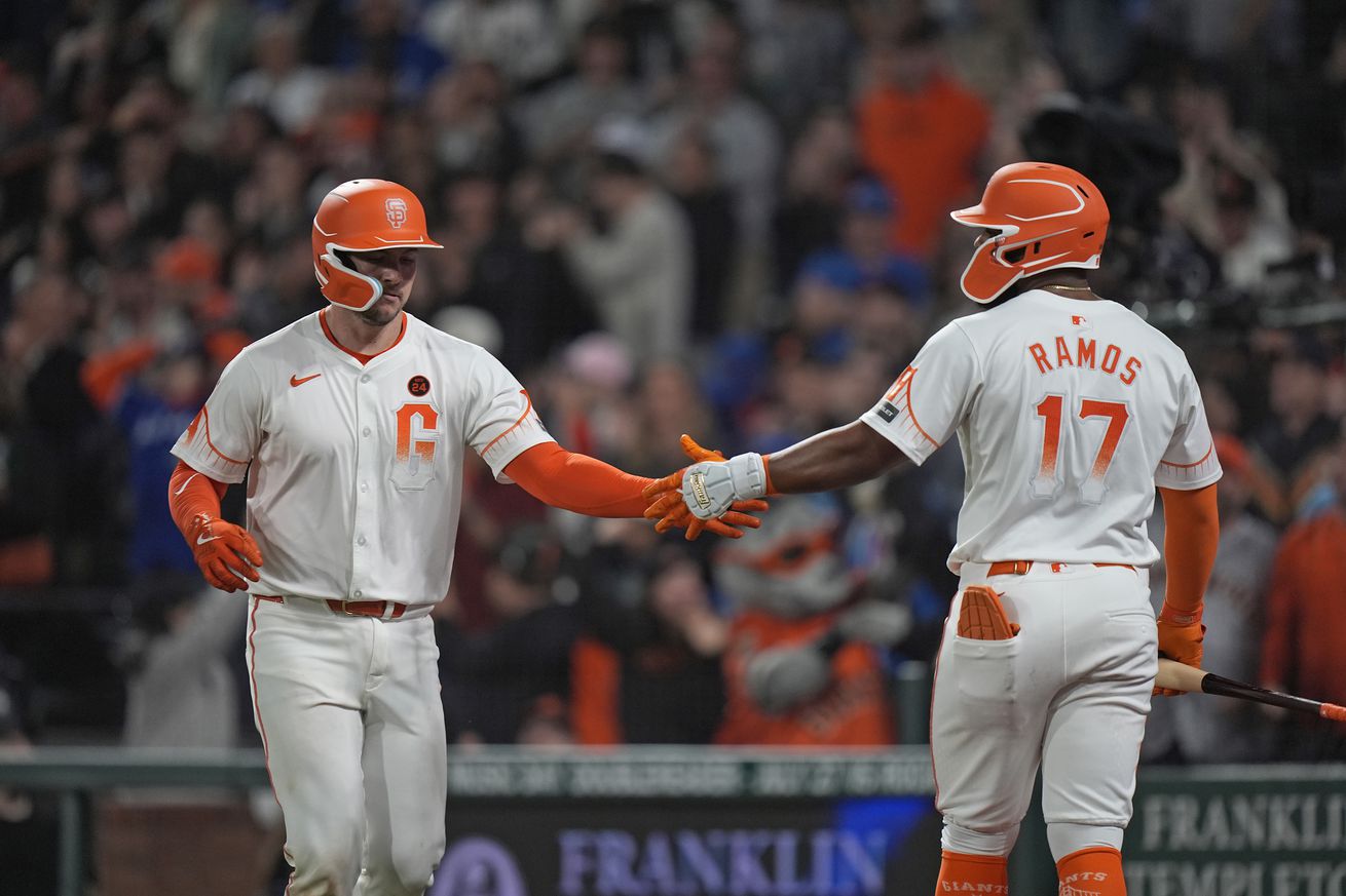 Patrick Bailey high-fives Heliot Ramos.