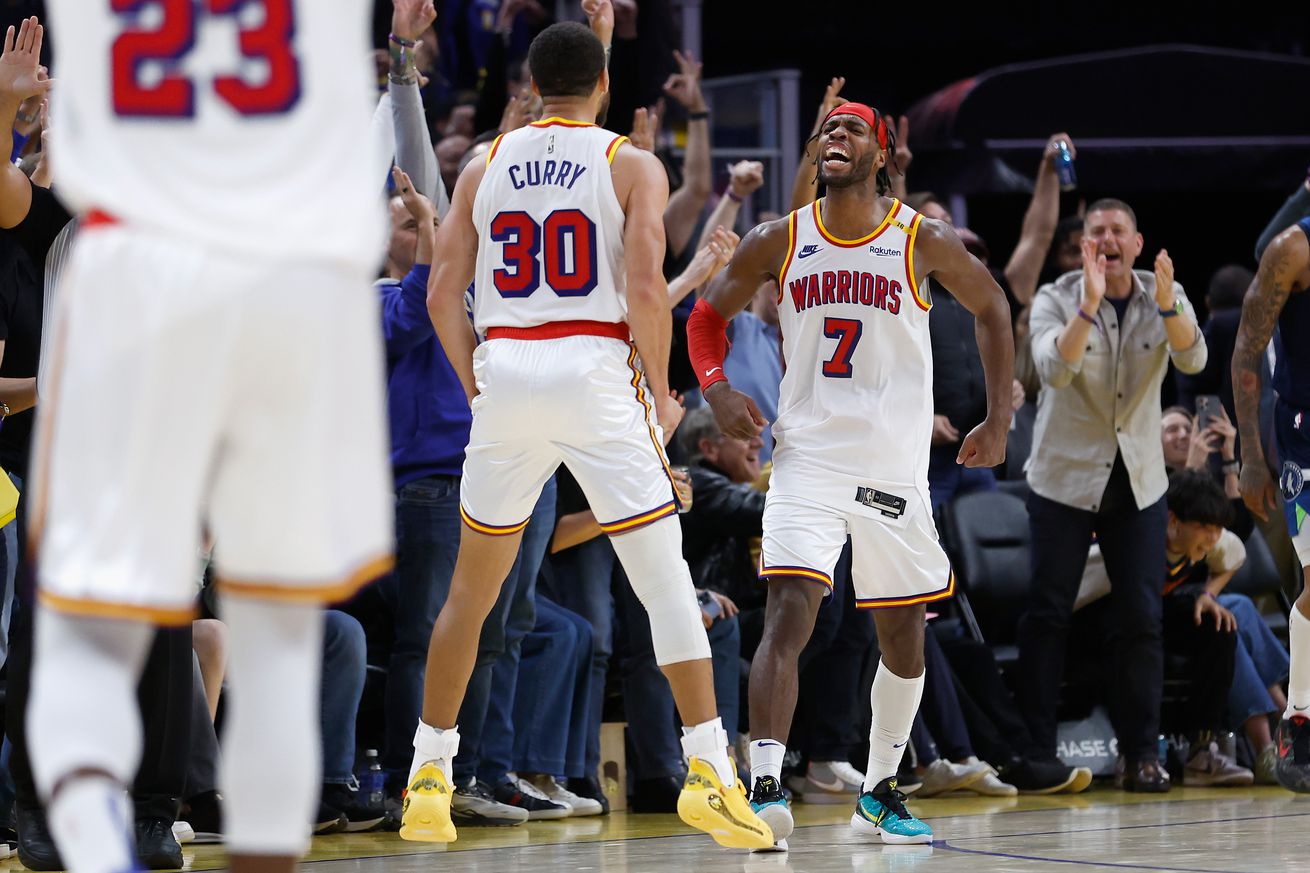 Steph Curry and Buddy Hield yell at each other in celebration. 