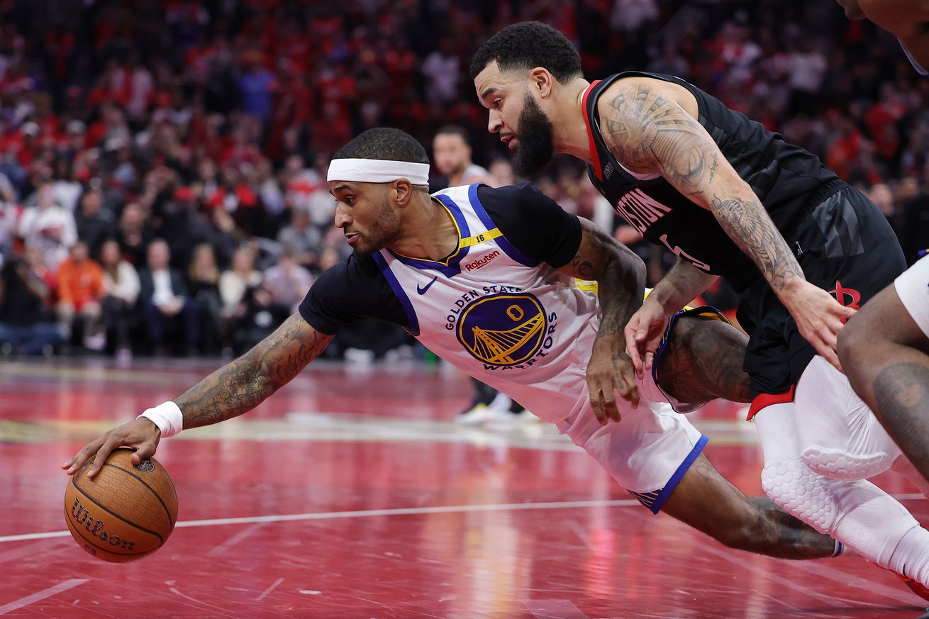 Gary Payton II and Fred VanVleet diving for a loose ball.