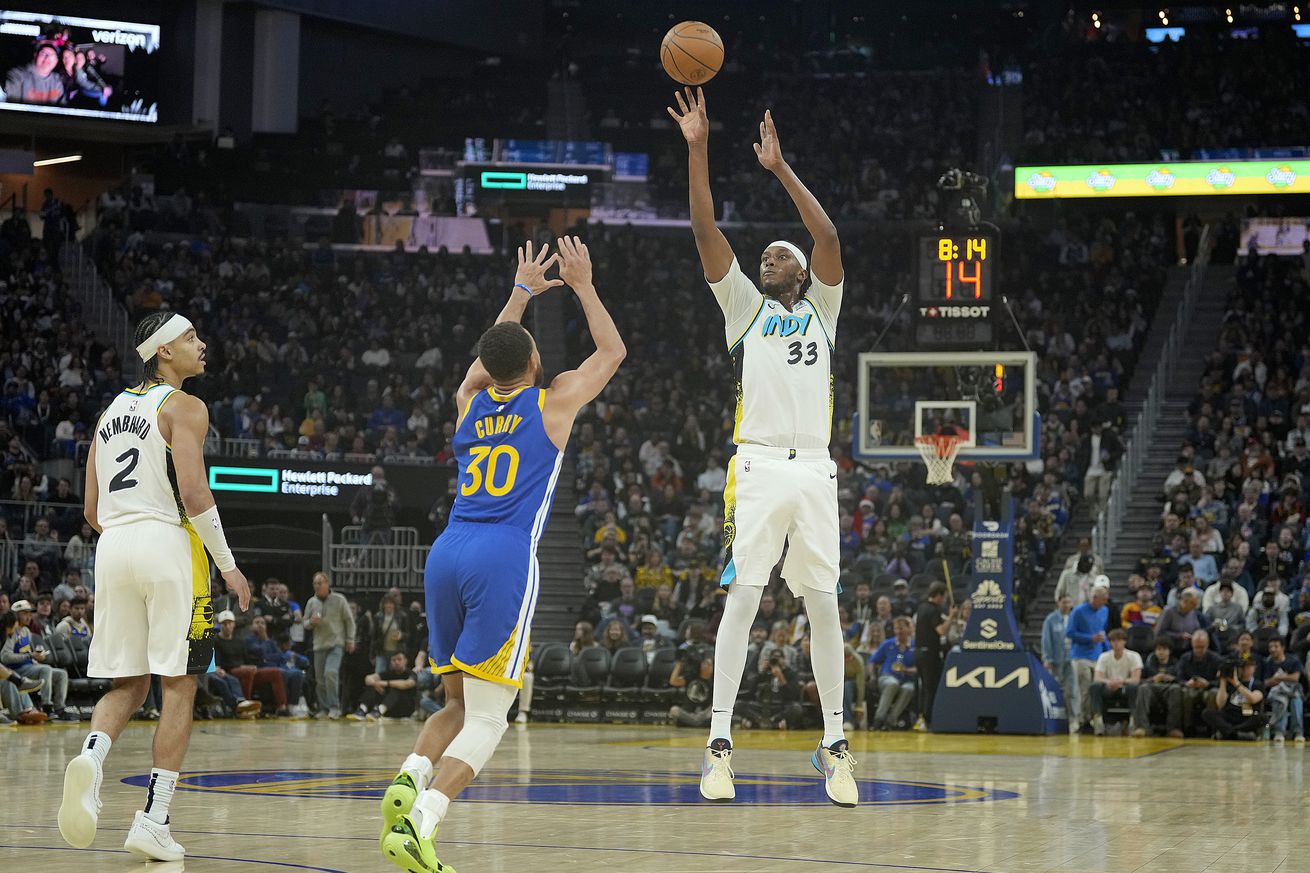 Steph Curry closing out as Myles Turner shoots a three. 