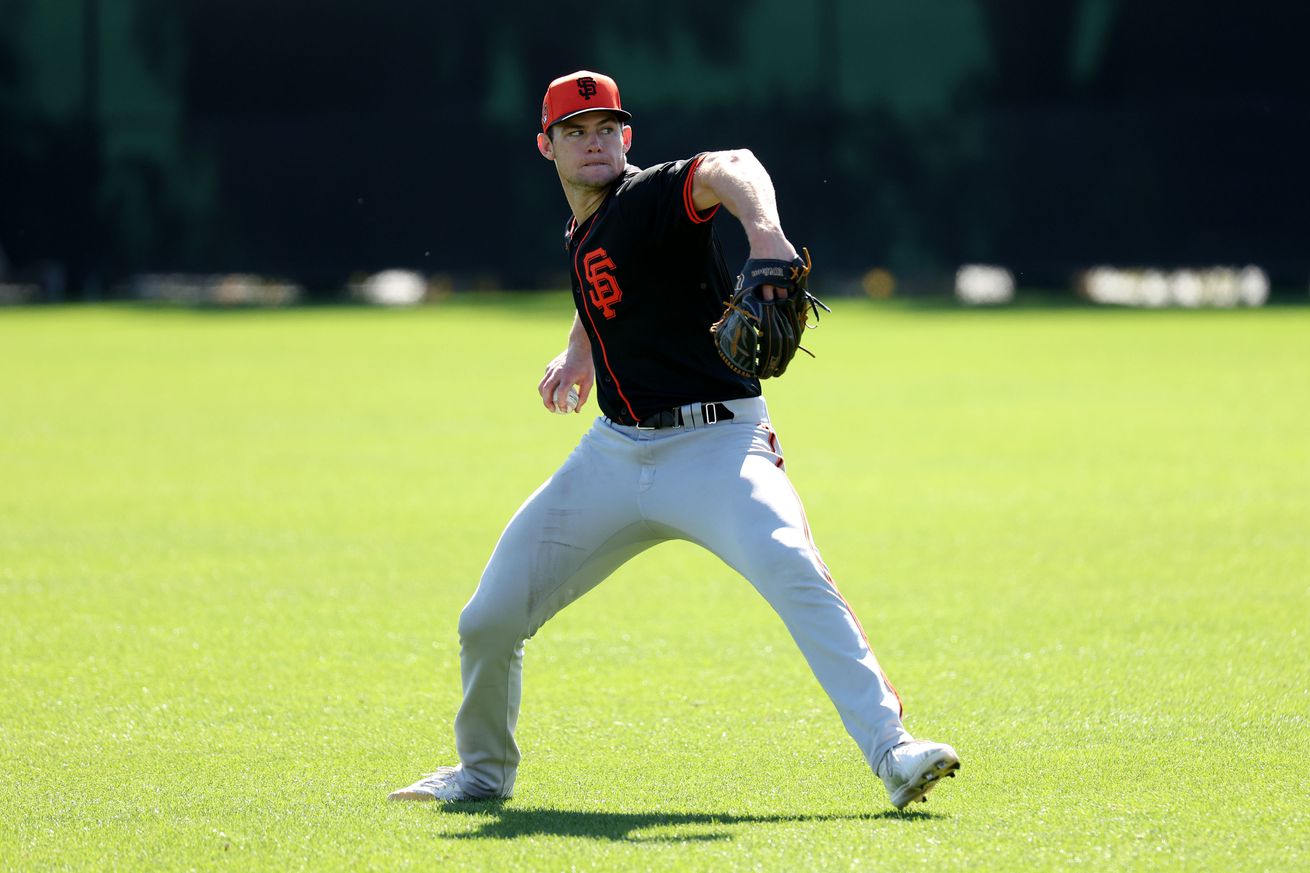 Carson Seymour throwing a pitch on a practice field. 