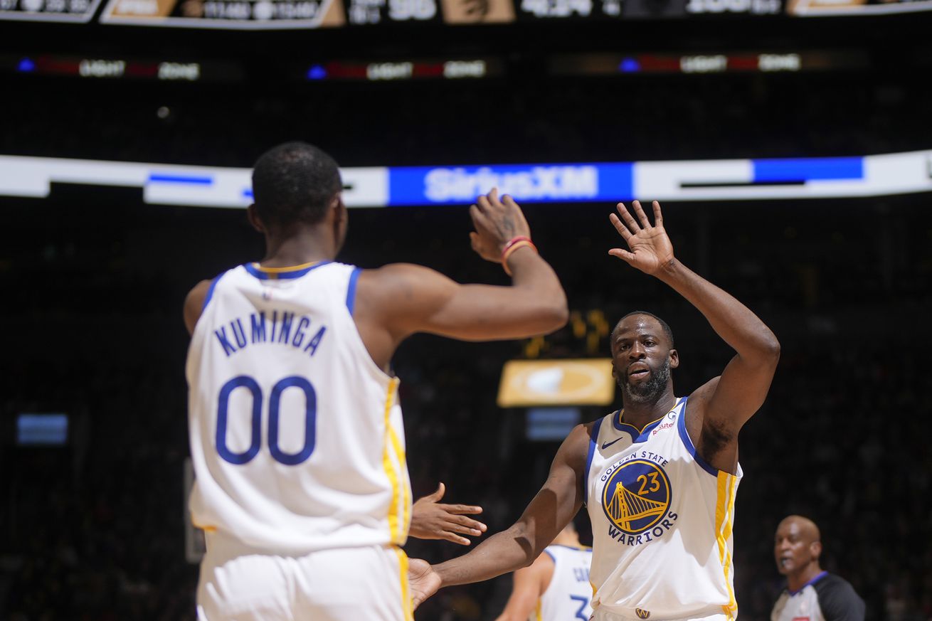 Draymond Green high-fiving Jonathan Kuminga.