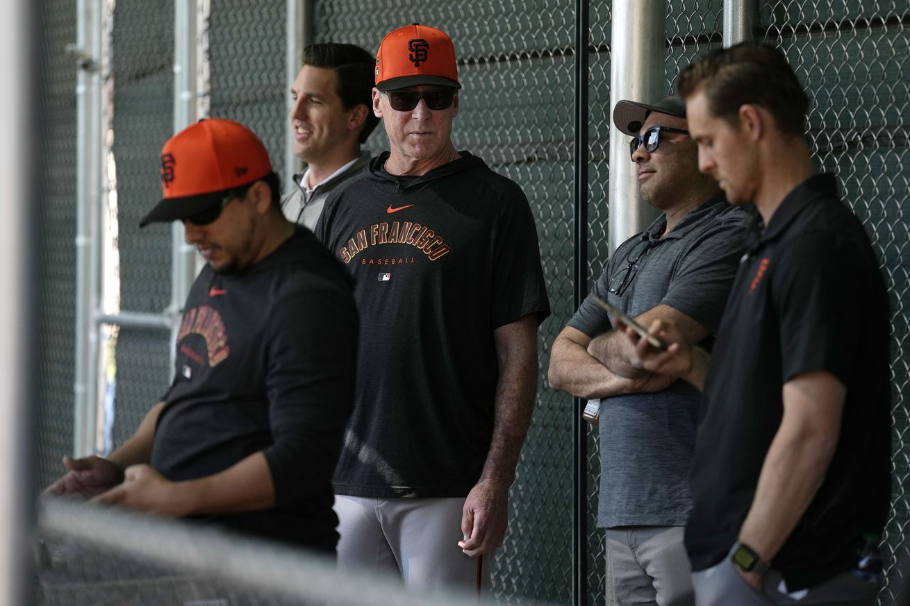 Bob Melvin talking with coaches at Spring Training. 