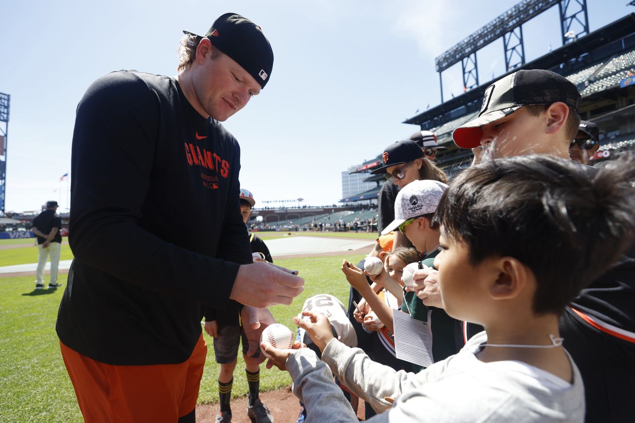 Logan Webb signing autographs for kids. 