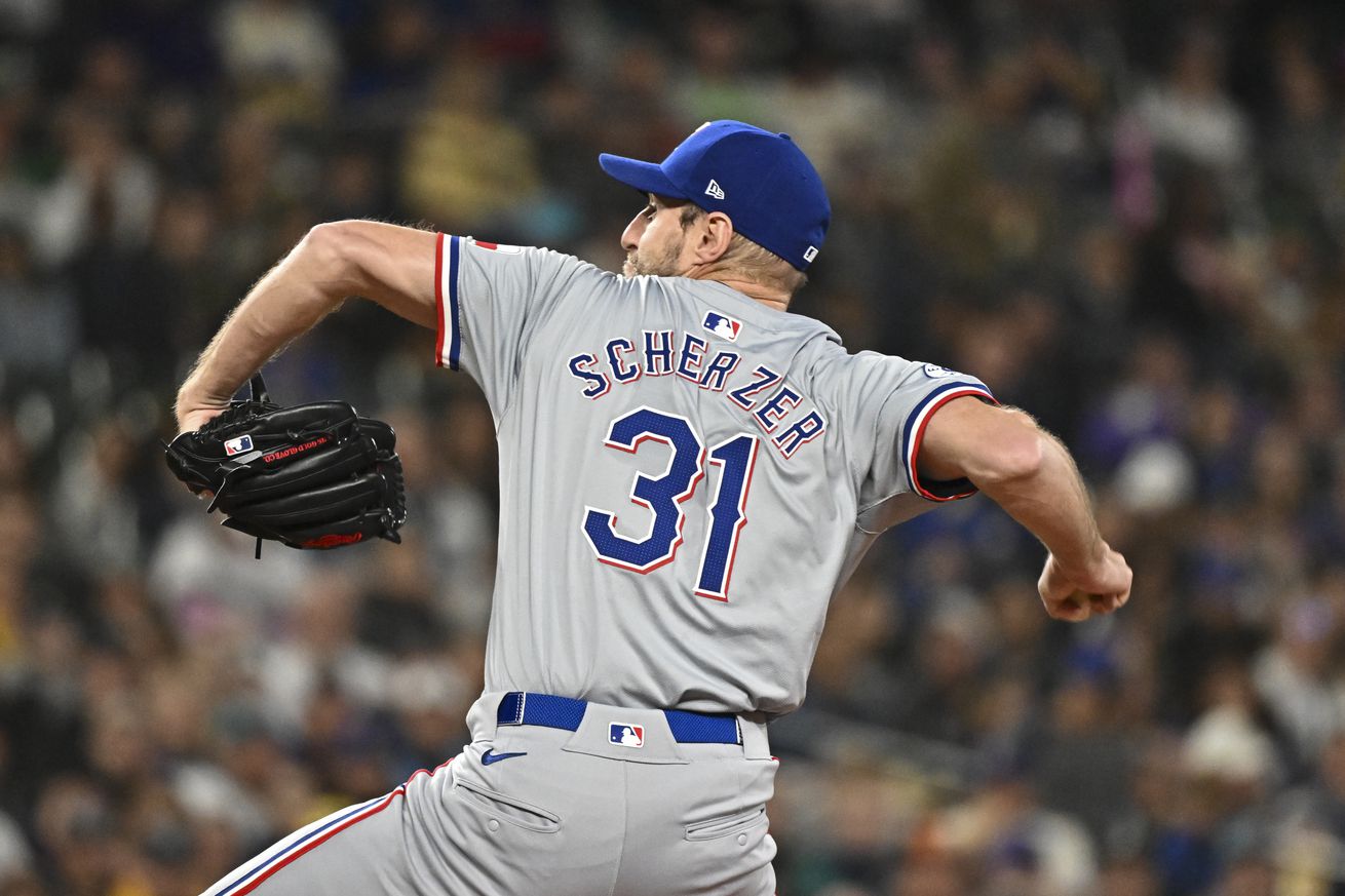 View from behind of Max Scherzer throwing a pitch. 