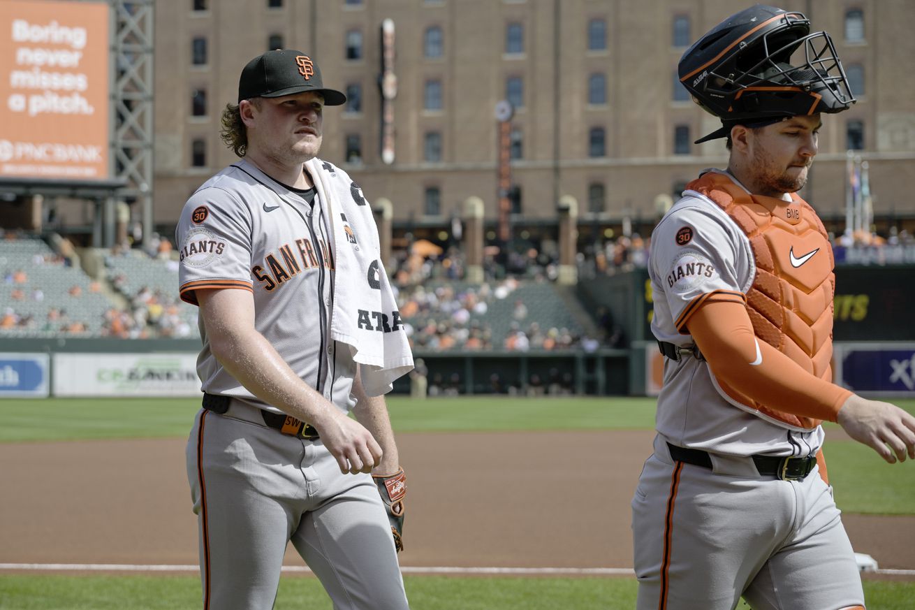 Logan Webb and Patrick Bailey walking off the field. 