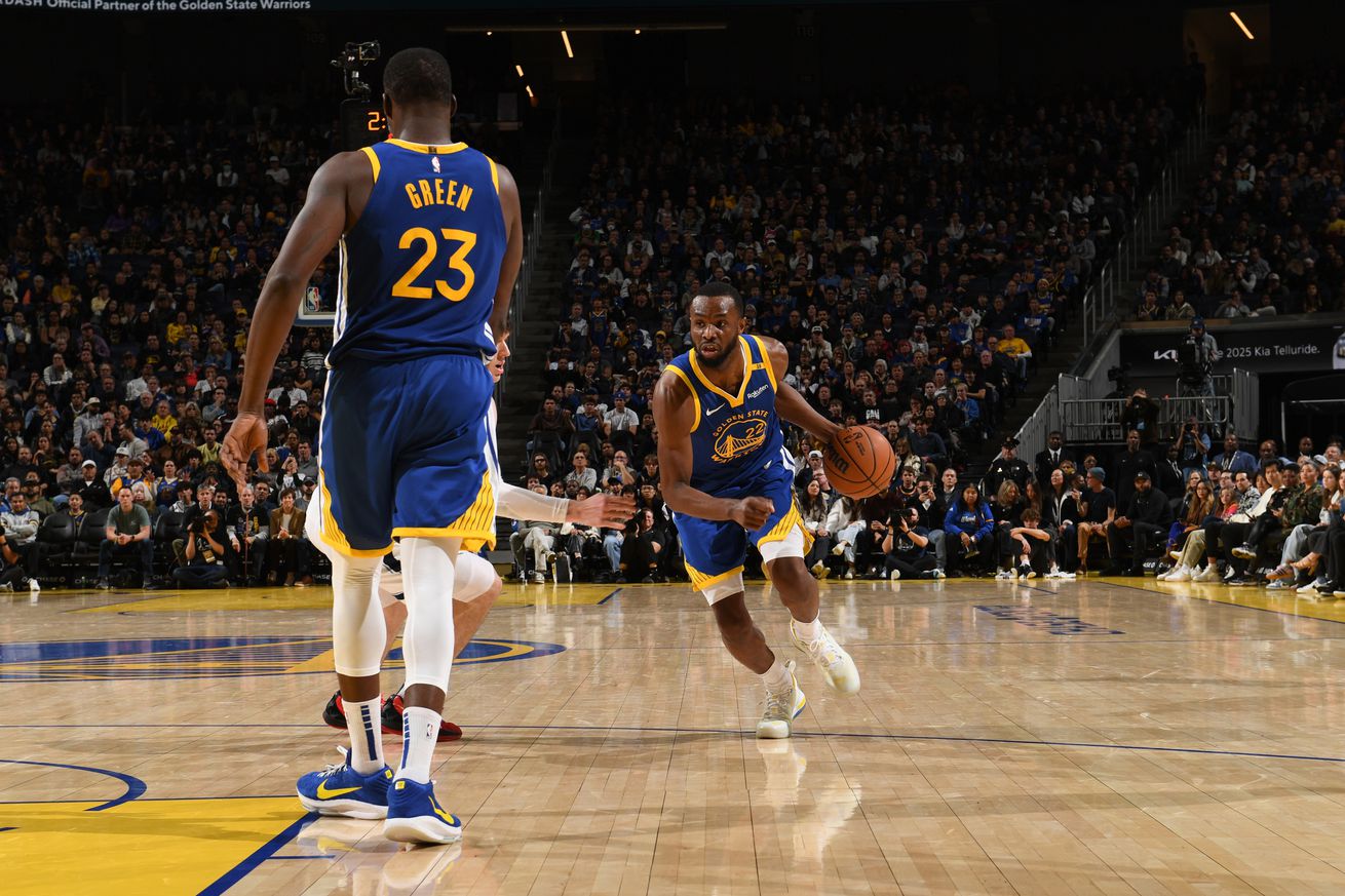 Andrew Wiggins dribbling towards Draymond Green. 