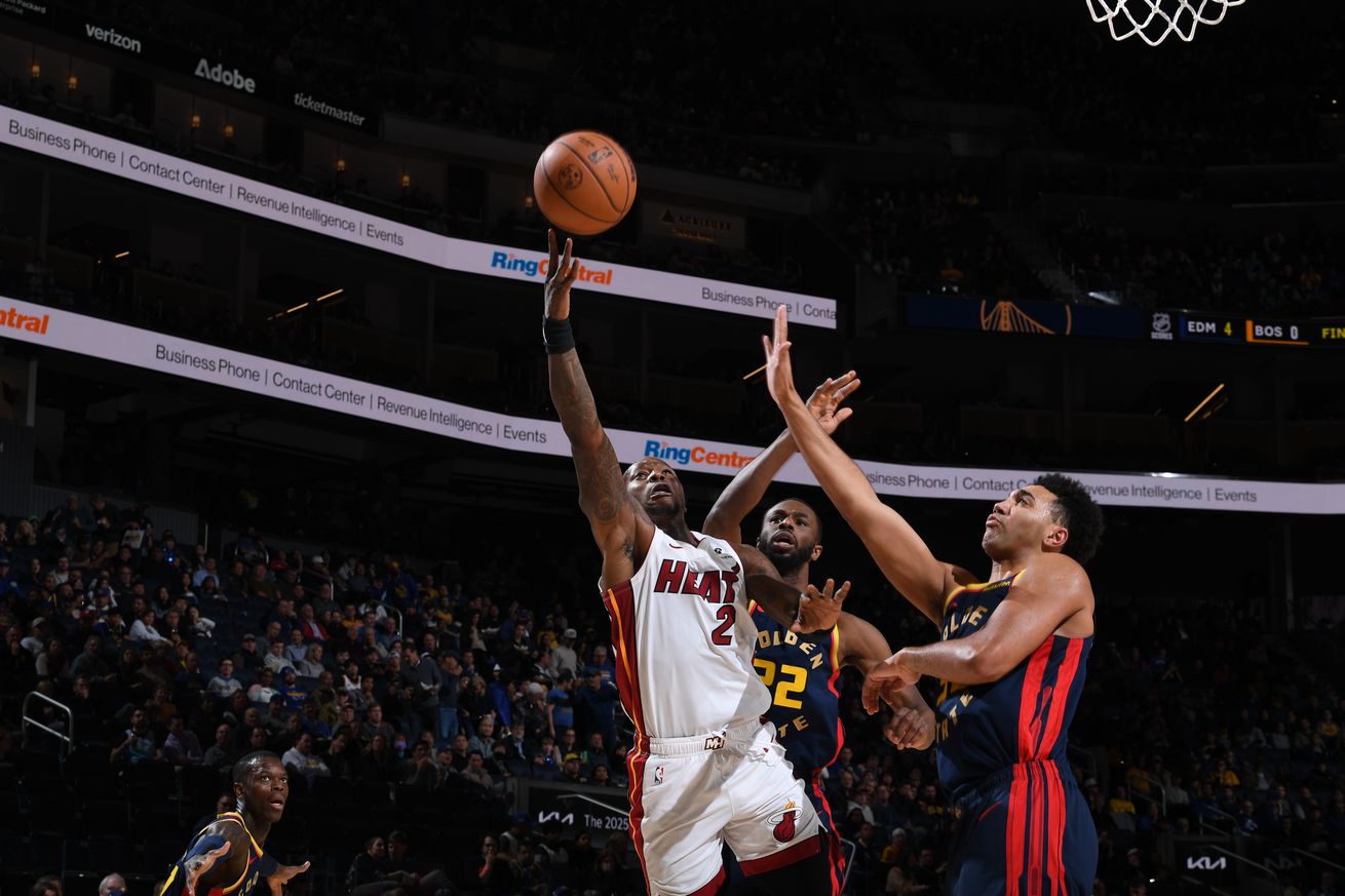 Andrew Wiggins and Trayce Jackson-Davis contesting a Terry Rozier layup attempt. 