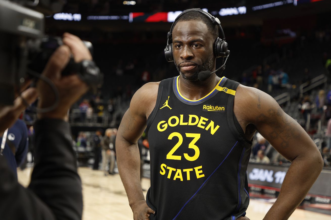 Draymond Green wearing a headset after a game. 