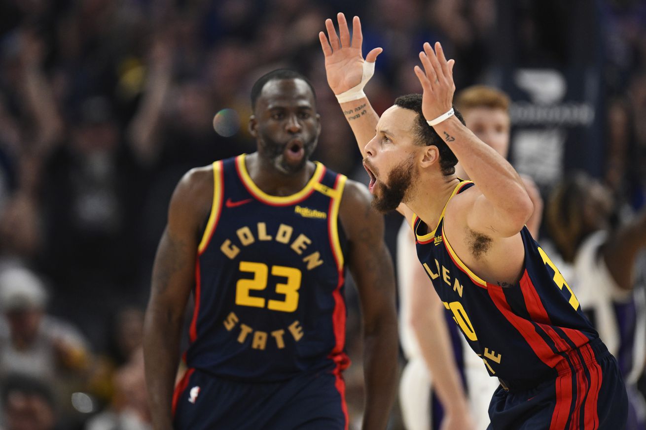 Steph Curry reacting with Draymond Green behind him. 