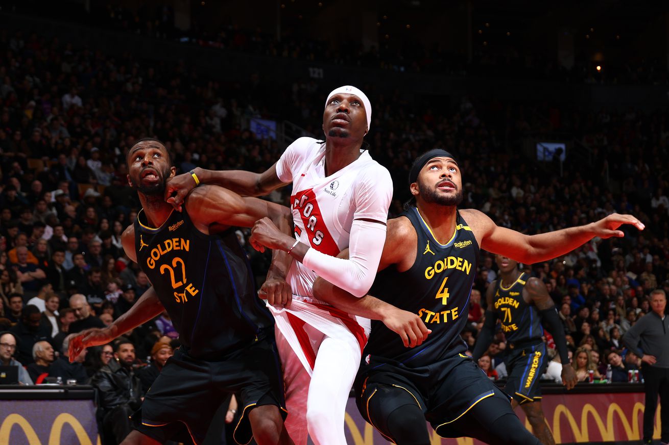 Chris Boucher fighting for a rebound, sandwiched between Andrew Wiggins and Moses Moody. 