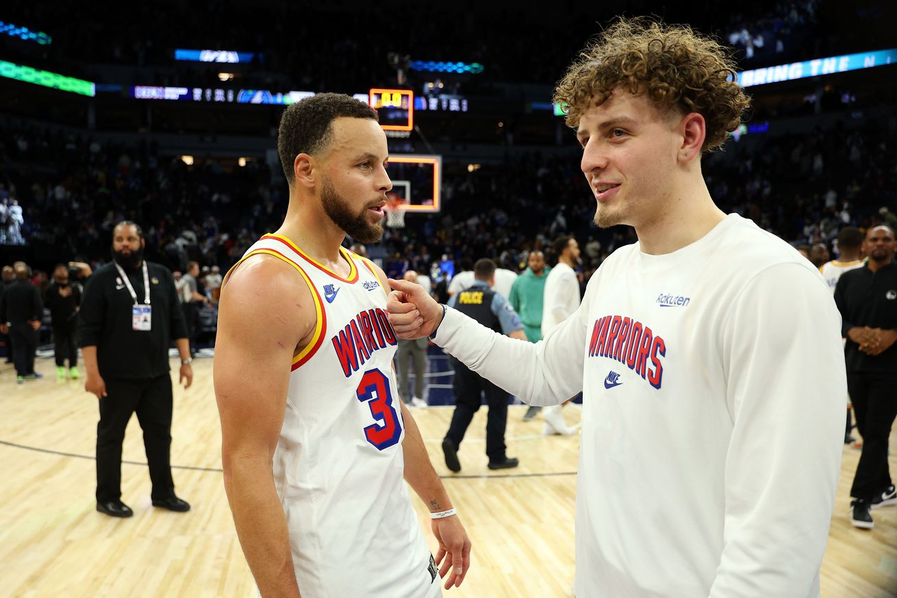 Steph Curry talking with Brandin Podziemski after a game.