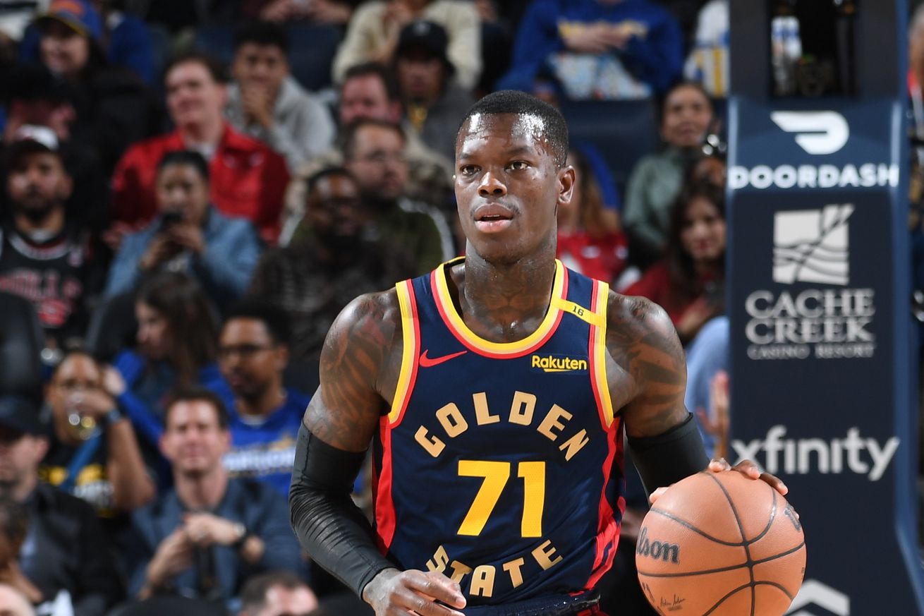 Dennis Schröder dribbling the ball with his left hand. 