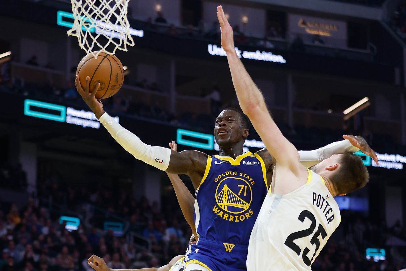 Dennis Schröder shooting a layup while colliding with Micah Potter. 