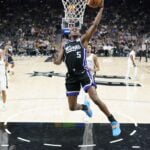 Sacramento Kings point guard De'Aaron Fox scores in game against the San Antonio Spurs