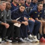 Golden State Warriors guard Stephen Curry (30), center, sits on the bench during the game against the Los Angeles Clippers at Intuit Dome.