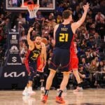 Golden State Warriors guard Stephen Curry and center Quinten Post celebrate a three-point basket