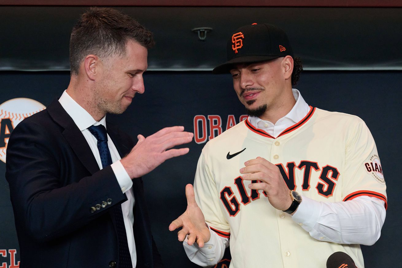 Buster Posey shaking hands with Willy Adames. 