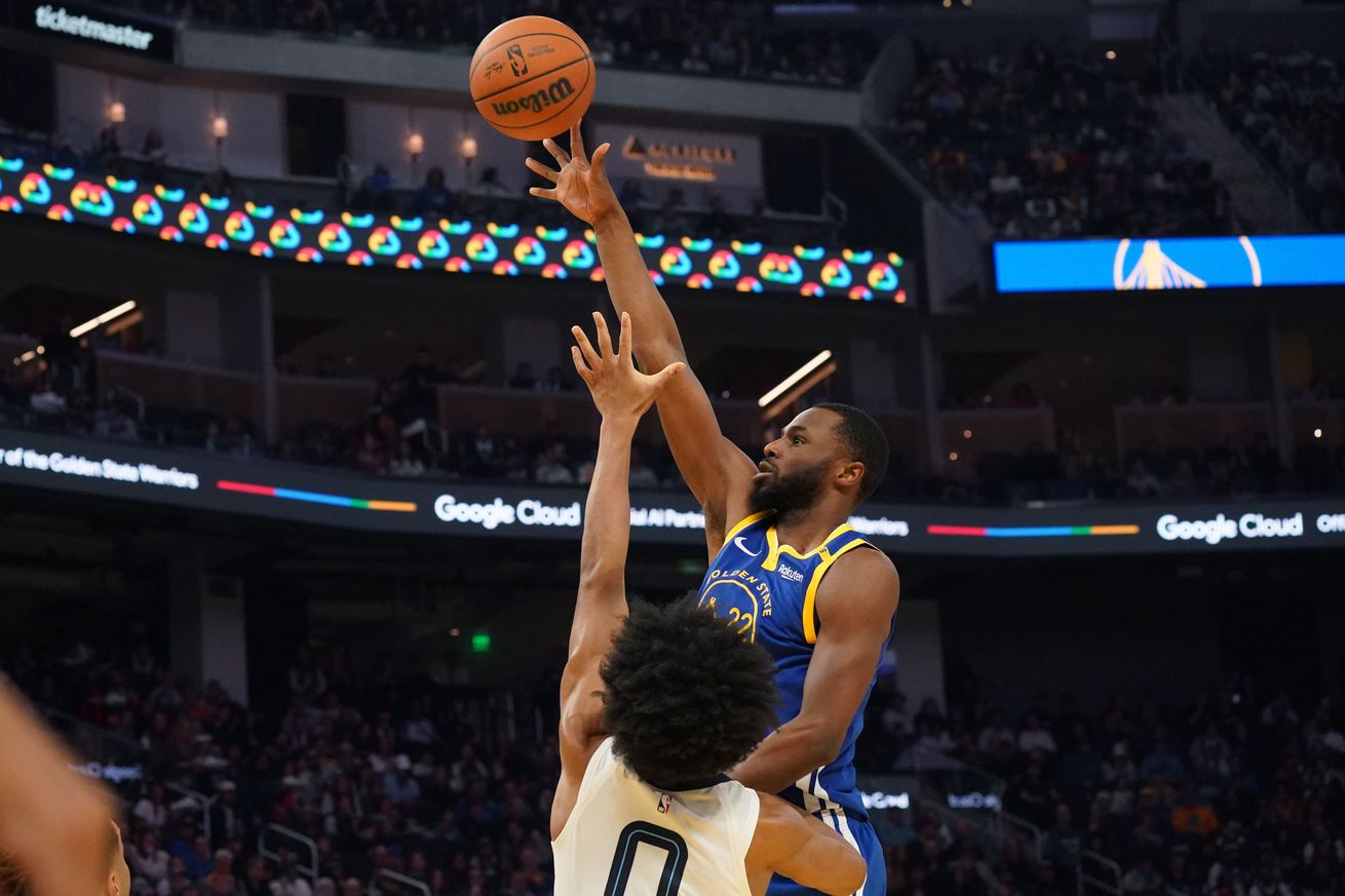 Andrew Wiggins shooting a floater over an outstretched arm. 