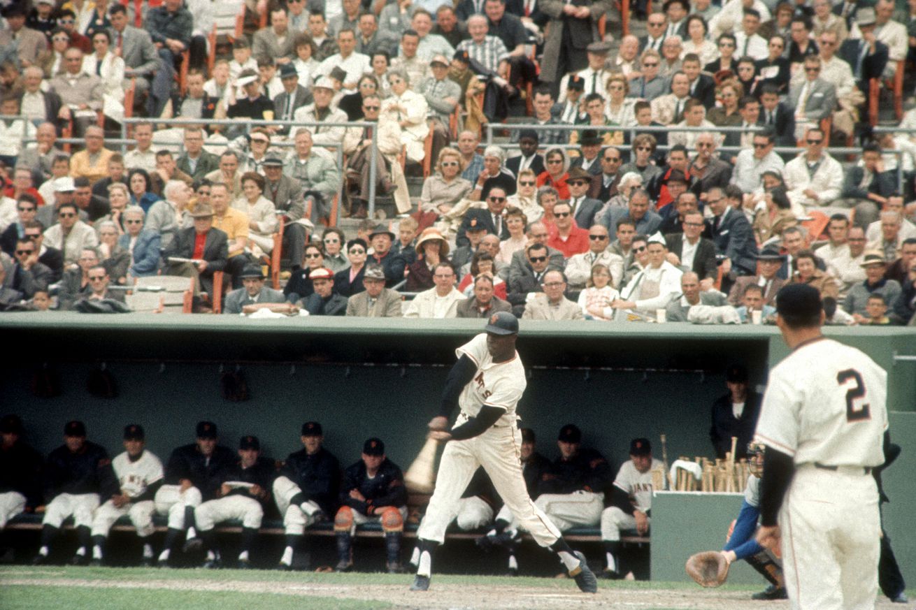 View from afar of Willie McCovey swinging a bat. 