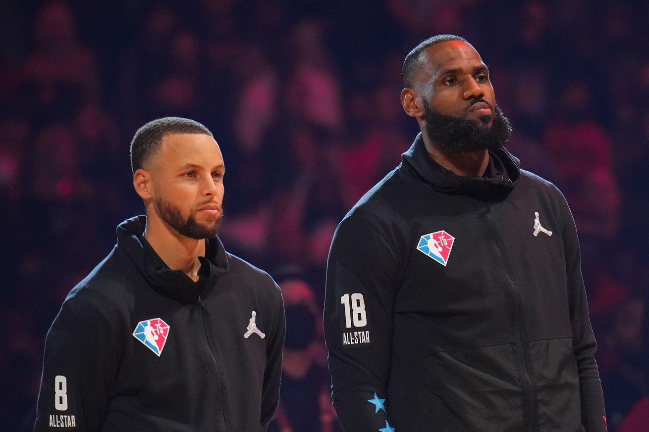 LeBron James standing next to Steph Curry during 2022 All-Star Game introductions. 