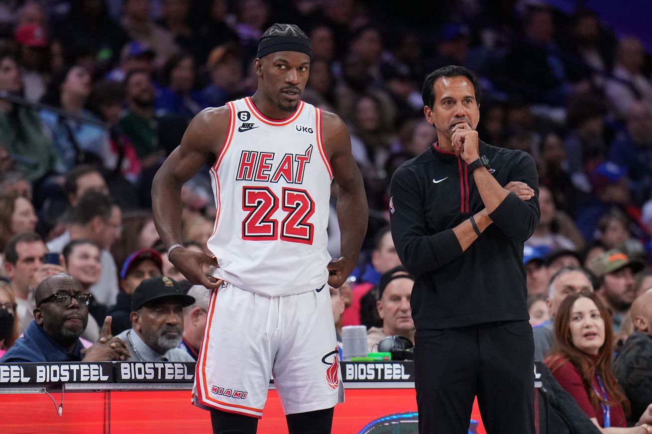 Jimmy Butler III standing next to Erik Spoelstra.