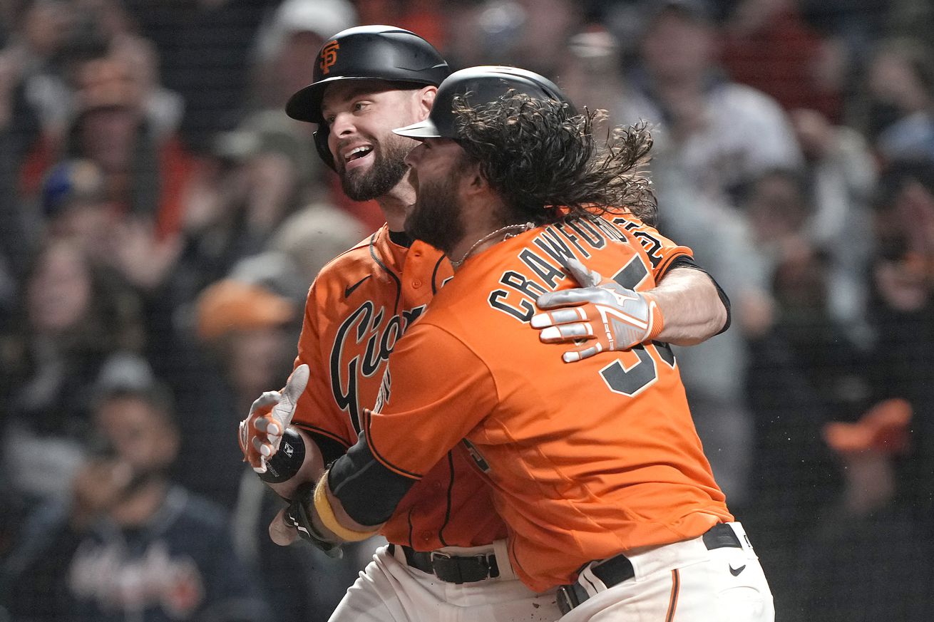 Brandon Belt and Brandon Crawford hugging. 