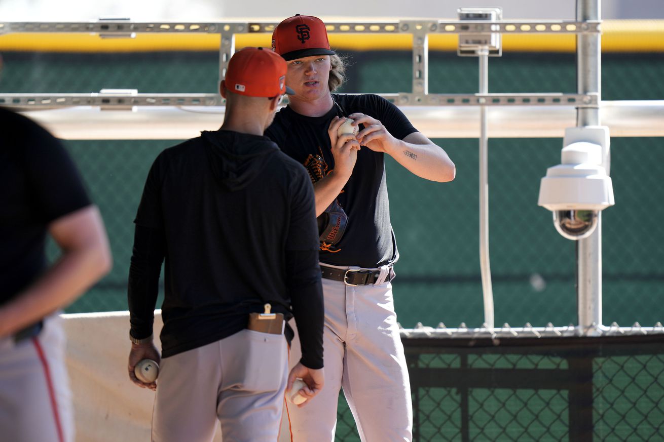 Hayden Birdsong talking with a coach during a bullpen session. 