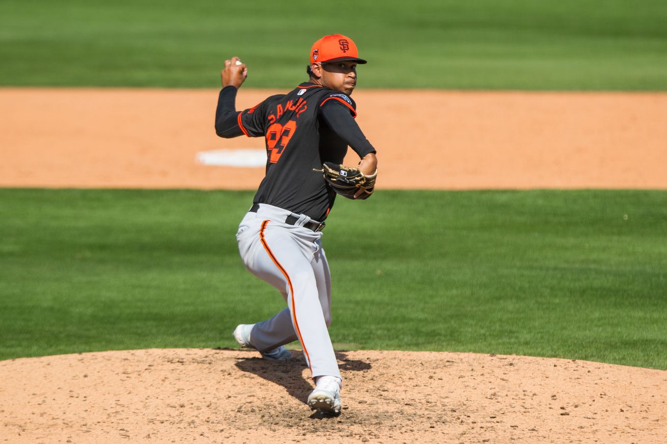 View from the front of Juan Sánchez throwing a pitch at Spring Training. 