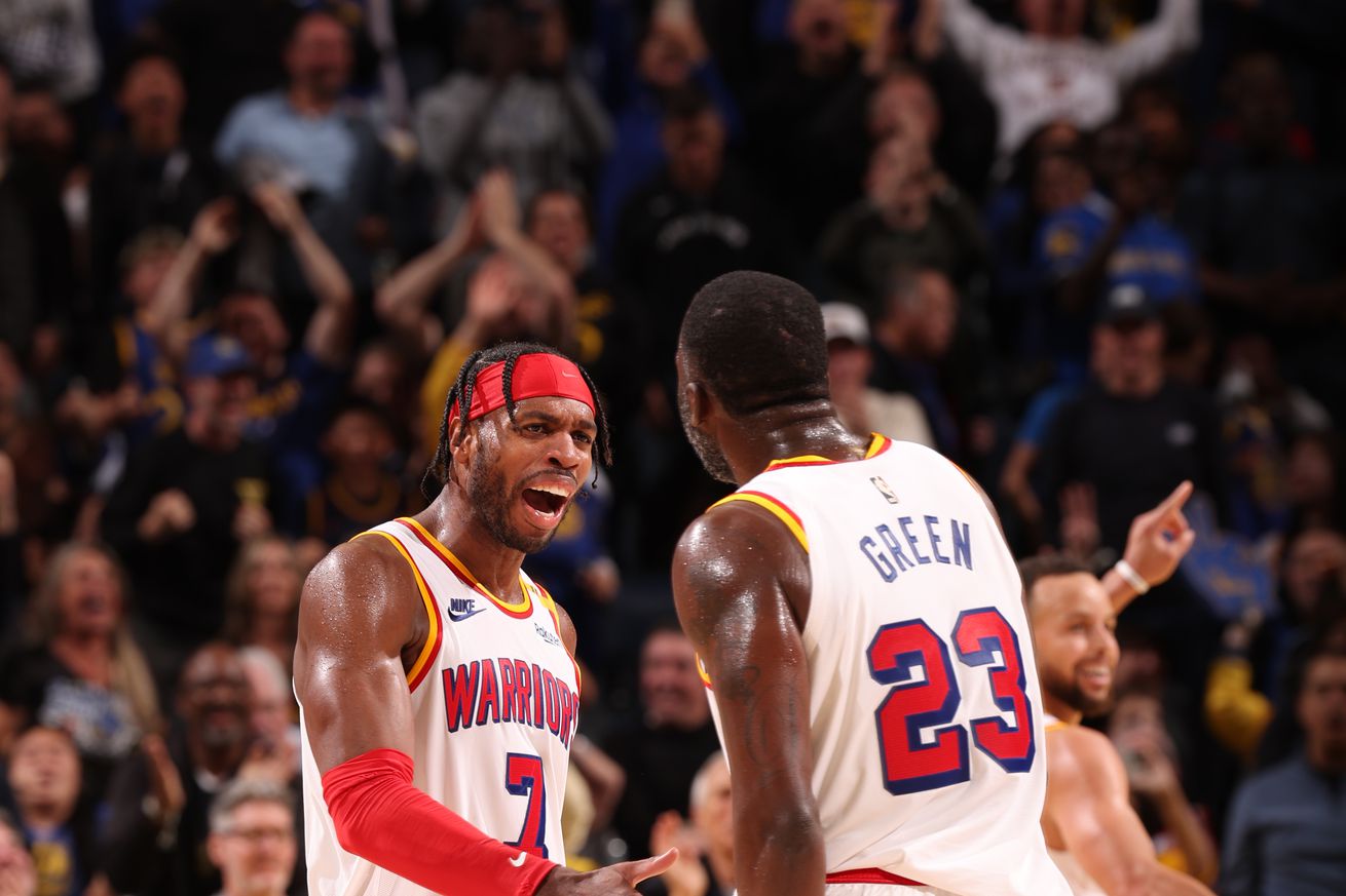 Draymond Green and Buddy Hield slapping hands. 