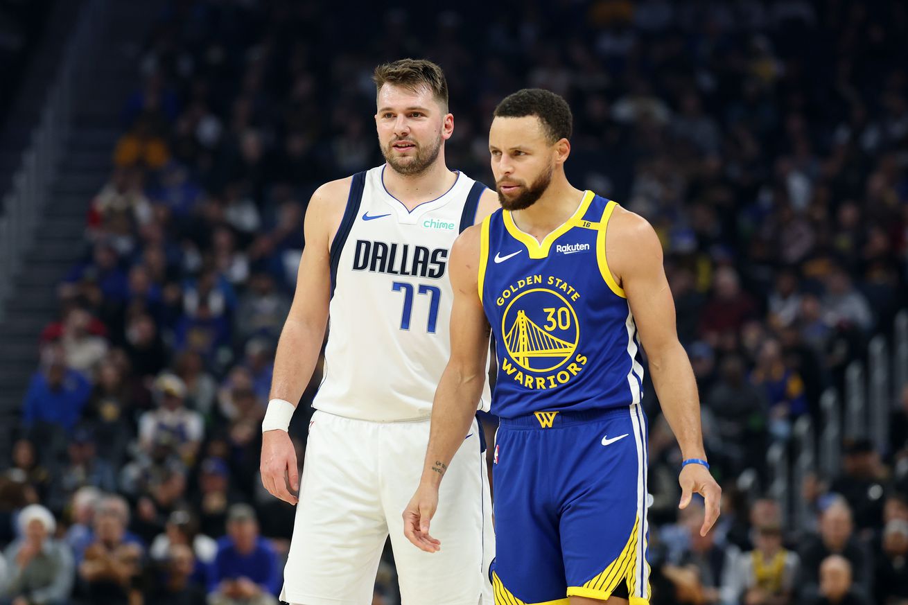 Steph Curry standing next to Luka Dončić.