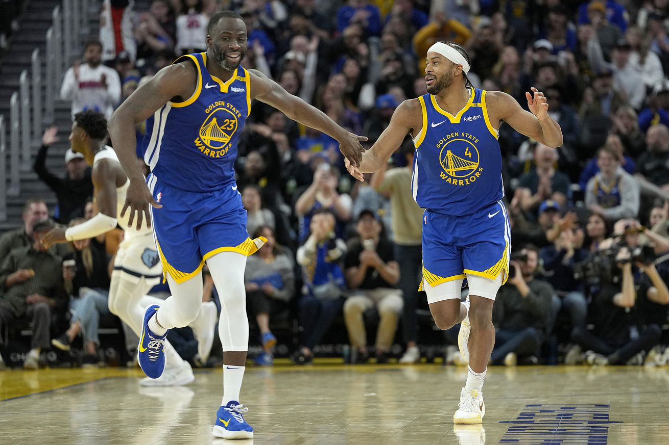 Moses Moody and Draymond Green running down the court. 