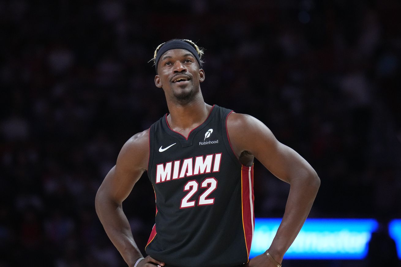 Jimmy Butler with hands on hips, smiling. 