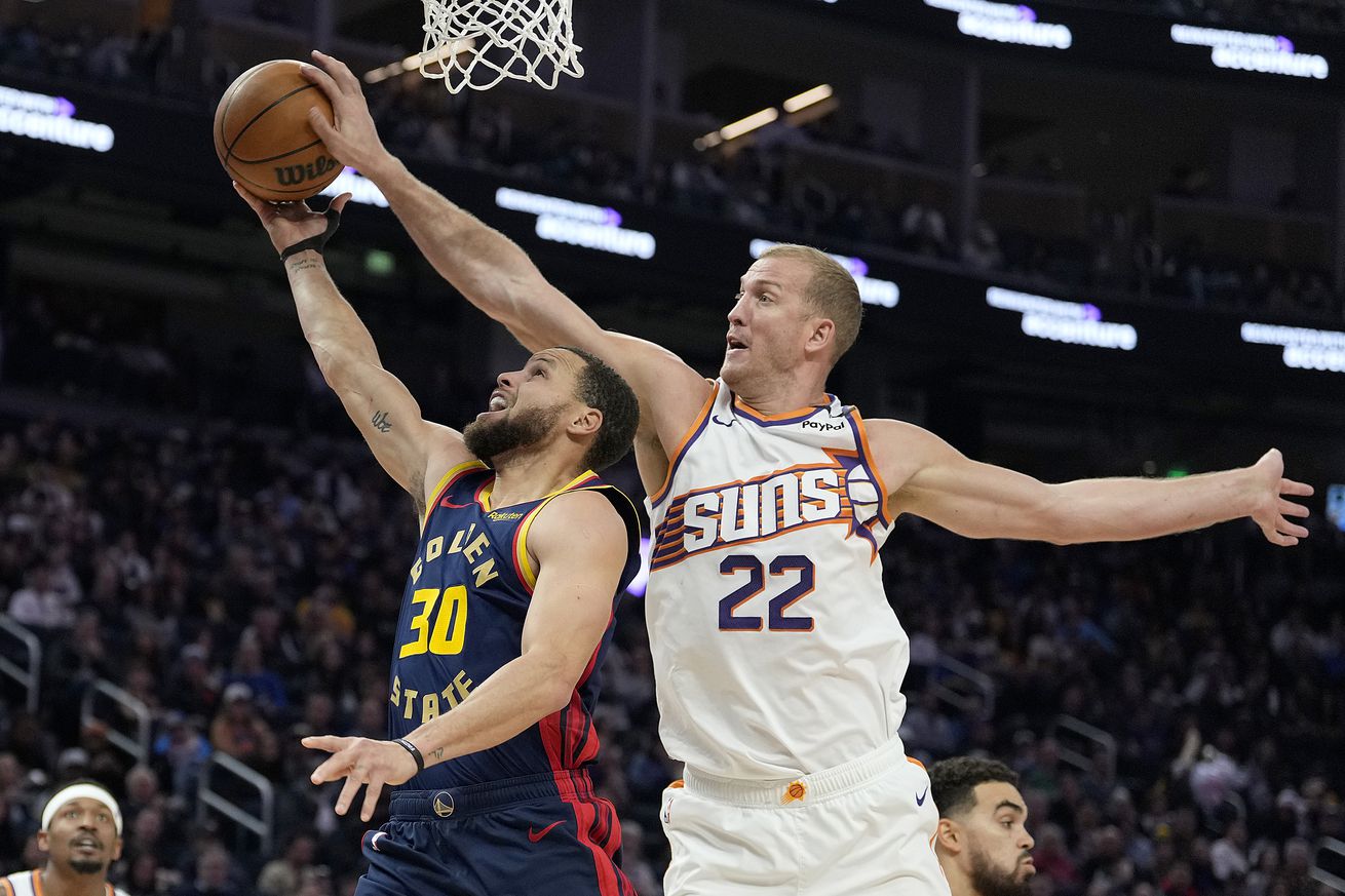 Mason Plumlee blocking a Steph Curry shot. 