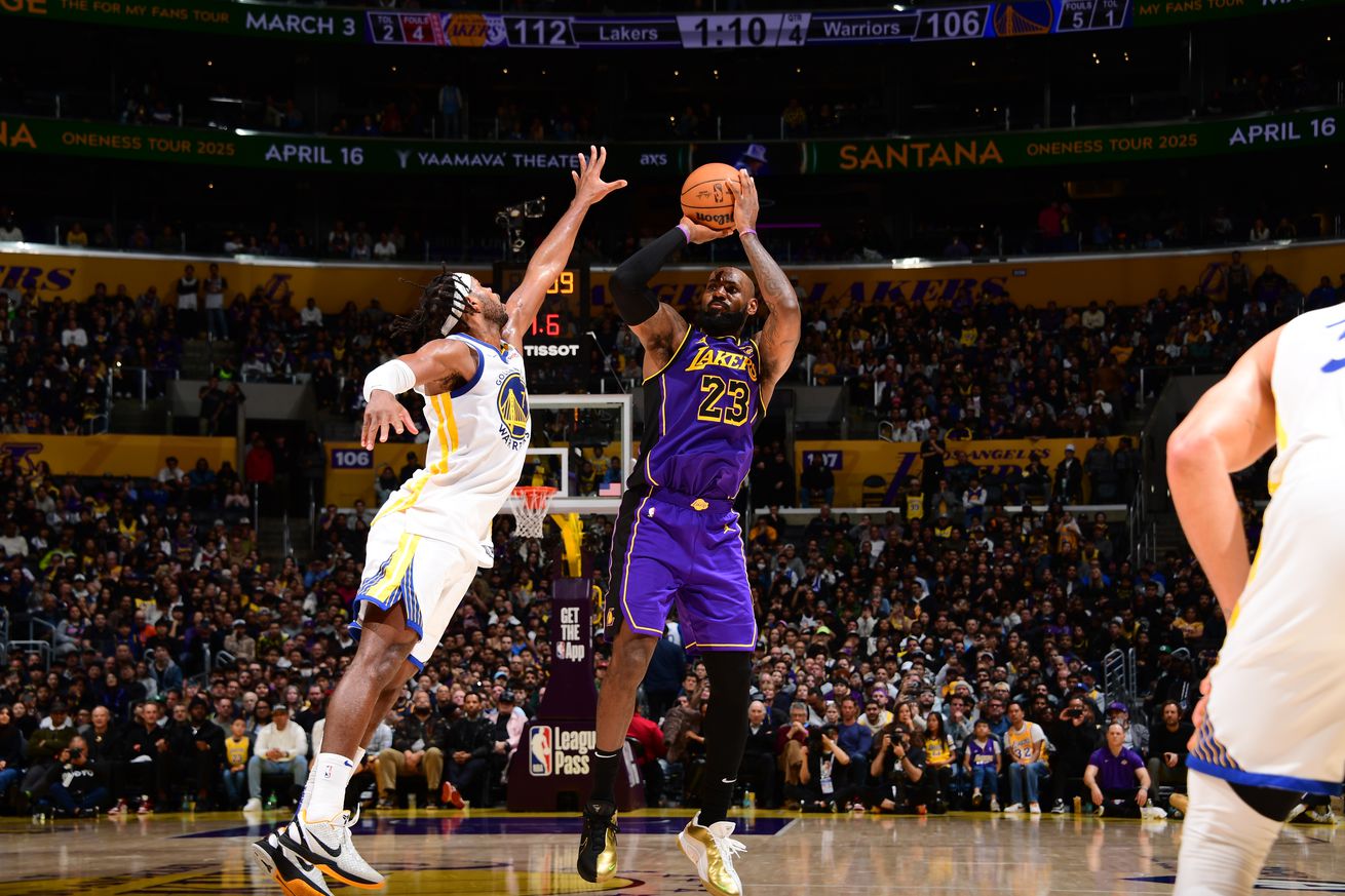 LeBron James shooting a jumper over the outstretched arm of a Warriors defender. 