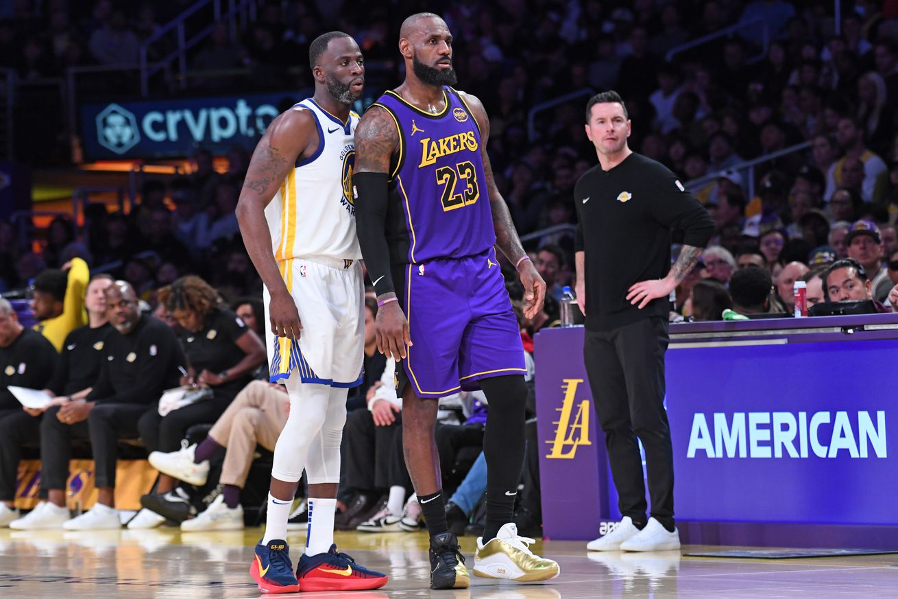 Draymond Green standing next to LeBron James.