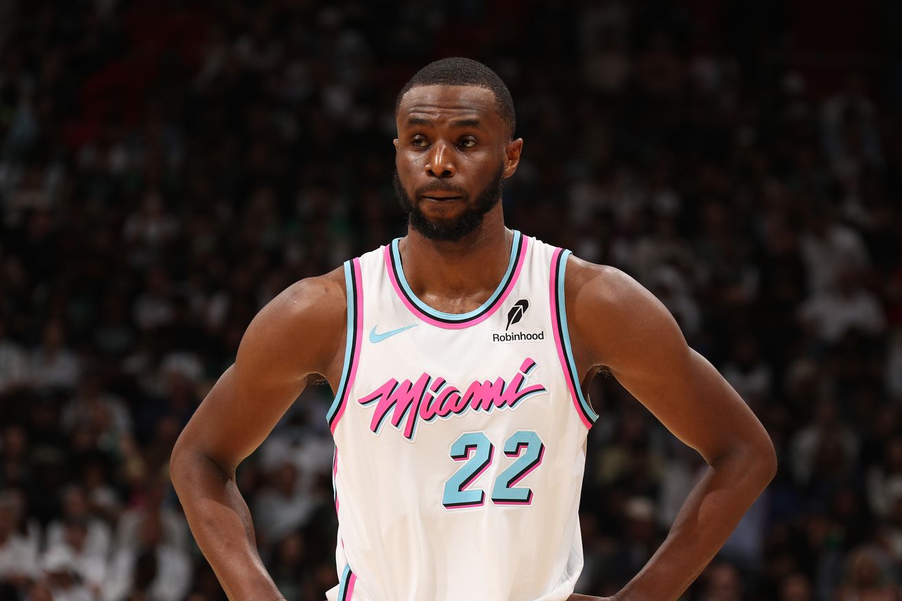 Andrew Wiggins with hands on hips wearing a Heat jersey. 