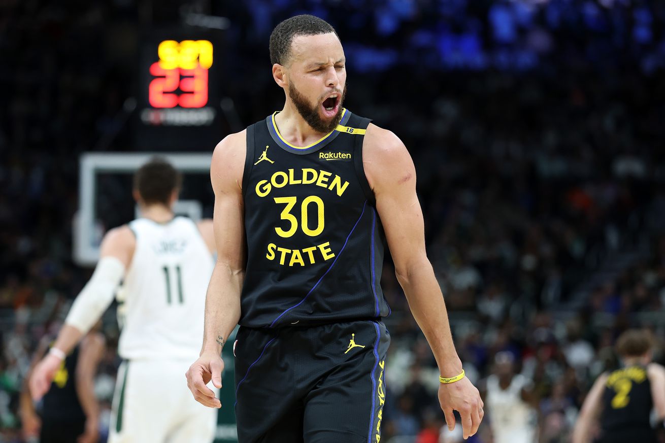 Steph Curry celebrating, with Brook Lopez behind him.