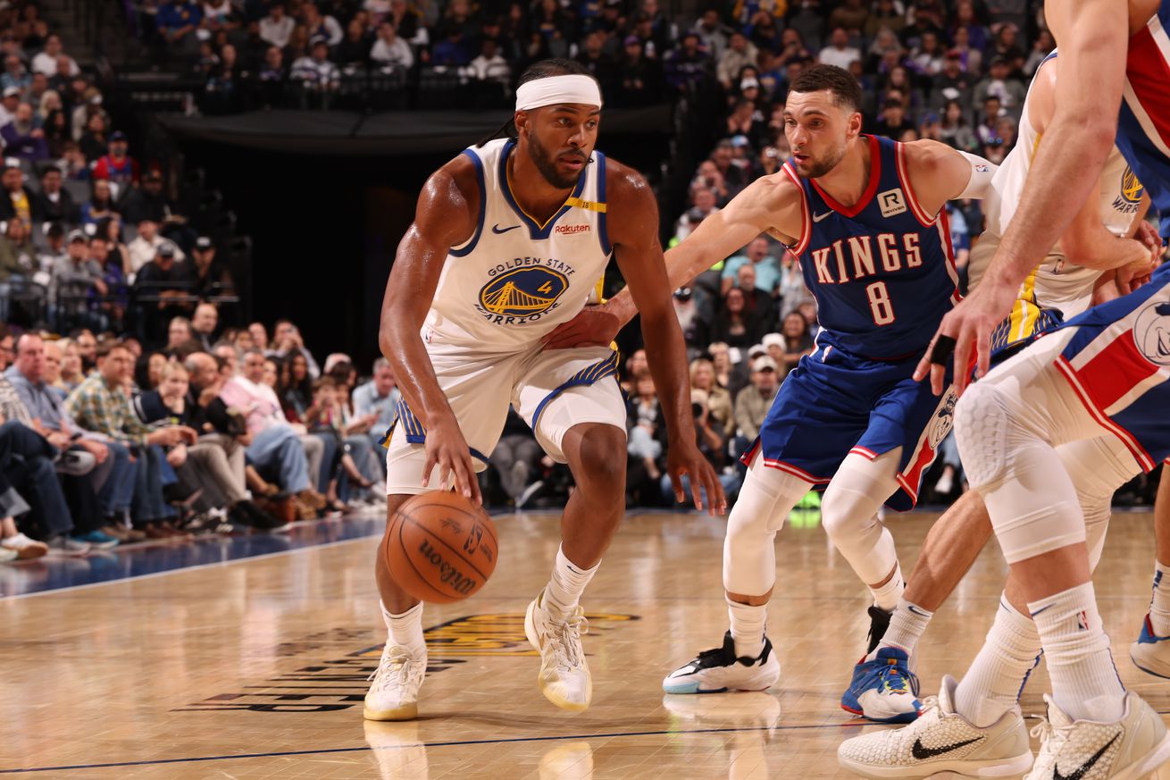 Moses Moody driving by Zach LaVine with his right hand. 