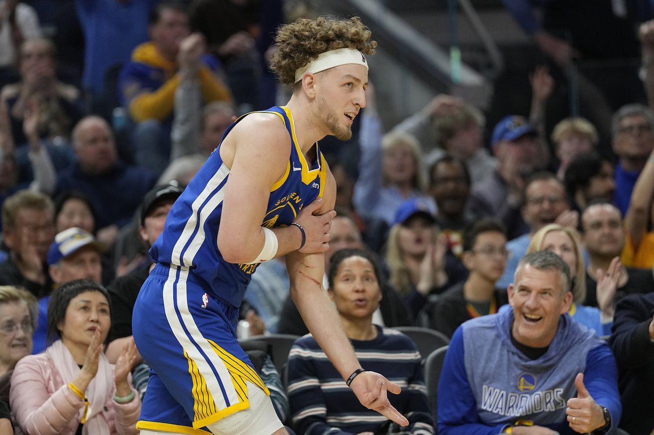 Brandin Podziemski holding his arm to celebrate a three.