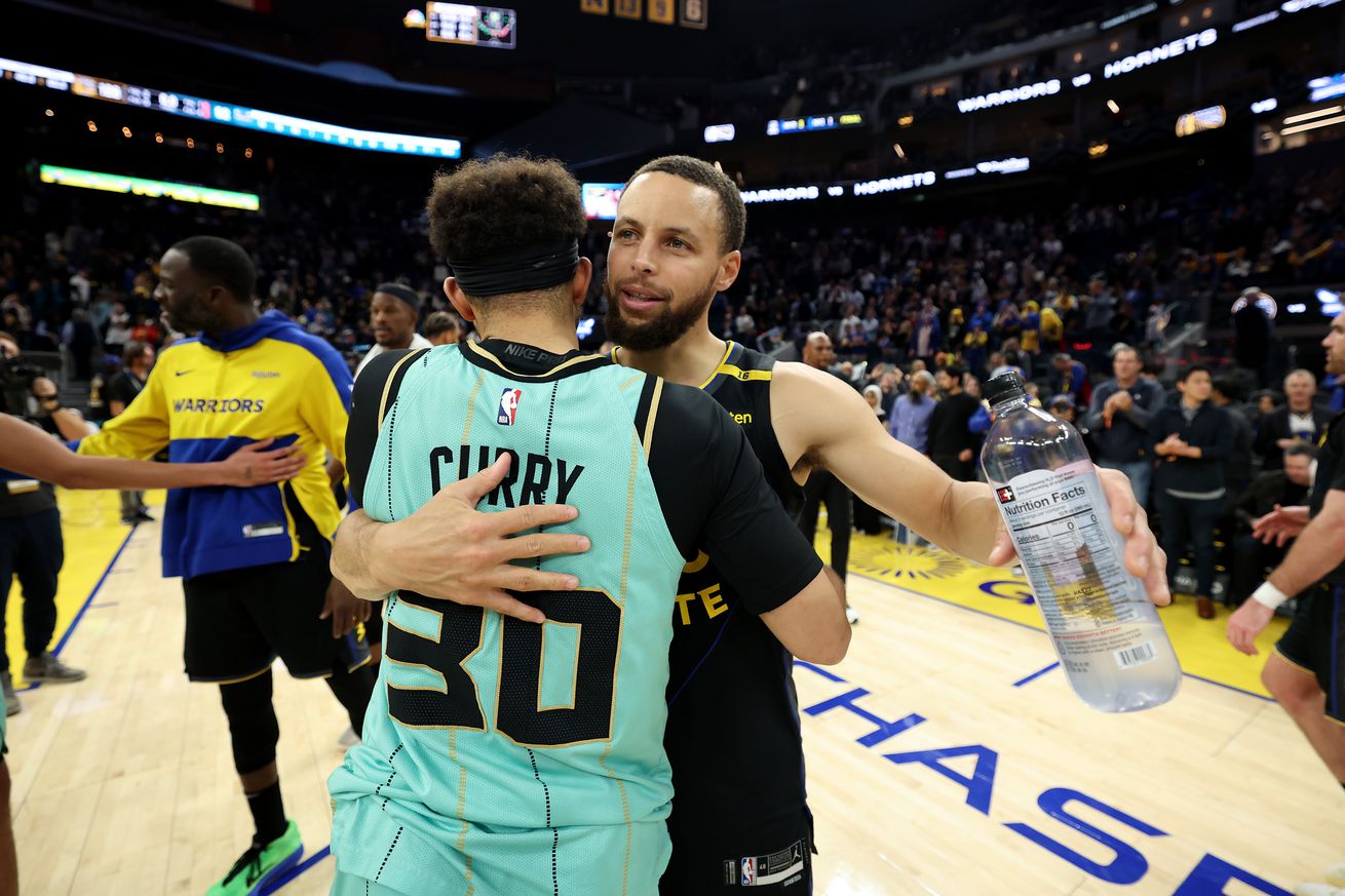 Steph Curry hugging Seth Curry. 