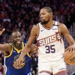 Dec 28, 2024; San Francisco, California, USA; Phoenix Suns forward Kevin Durant (35) controls the ball against Golden State Warriors forward Draymond Green (23) during the third quarter at Chase Center. Mandatory Credit: Robert Edwards-Imagn Images