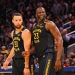 Feb 3, 2025; San Francisco, California, USA; Golden State Warriors guard Stephen Curry (30) and forward Draymond Green (23) look towards an Orlando Magic player at half time at Chase Center. Mandatory Credit: Kelley L Cox-Imagn Images