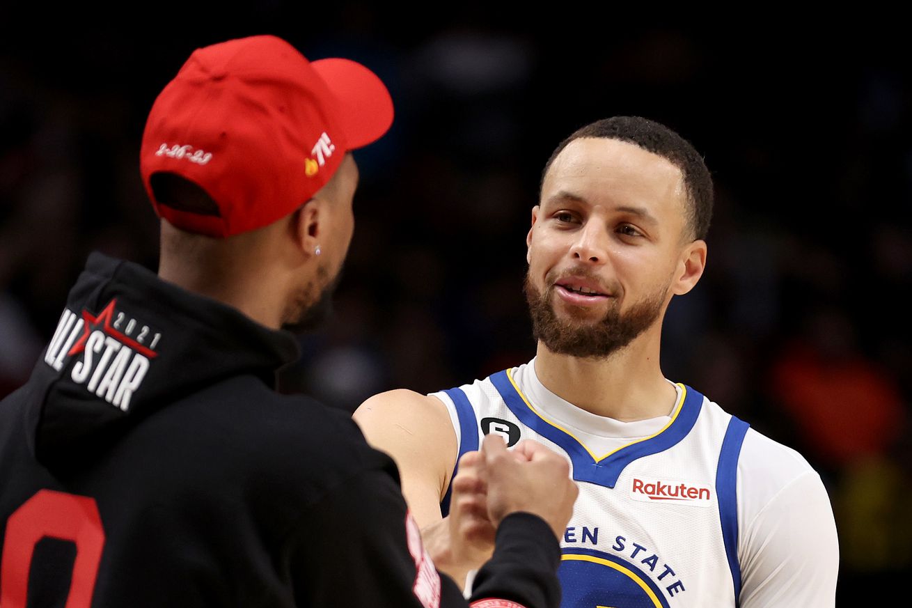 Steph Curry hugging Damian Lillard. 